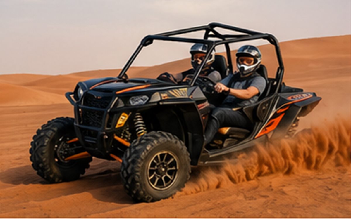 Dune buggy crossing red desert dunes