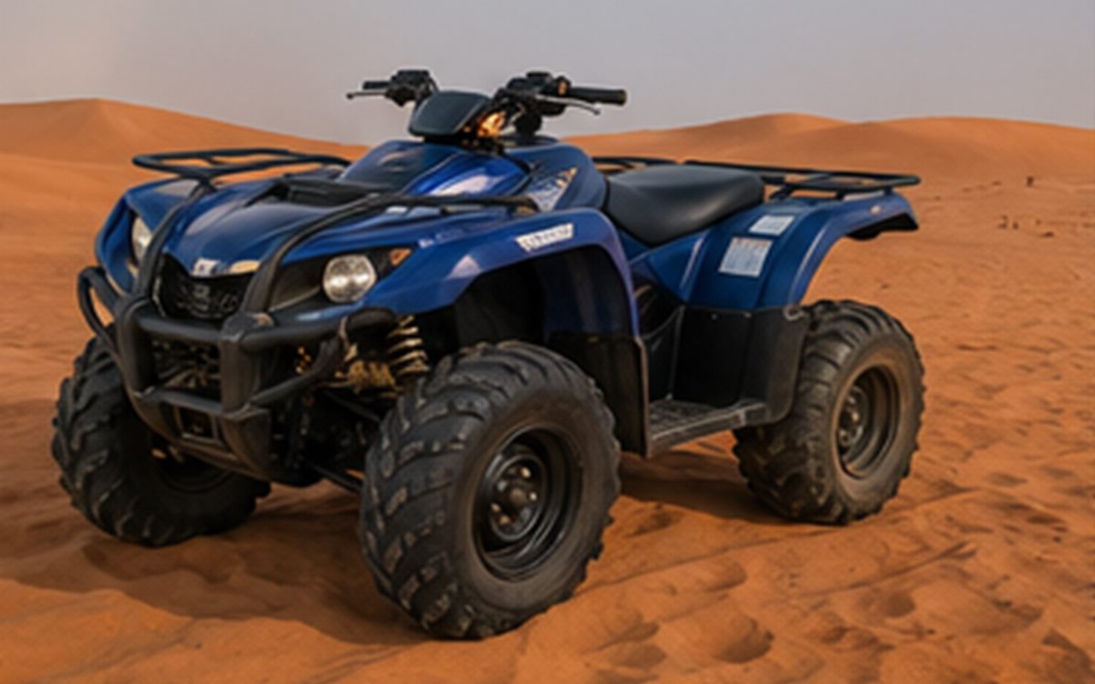 Blue Yamaha-style grizzly quad bike on desert dunes