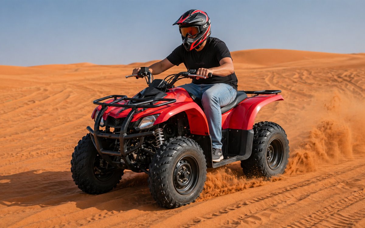 Red single seater quad bike in desert sand